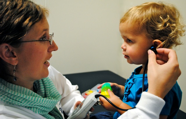 a child participating in a hearing screening test
