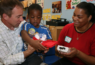 a child participating in a hearing screening test