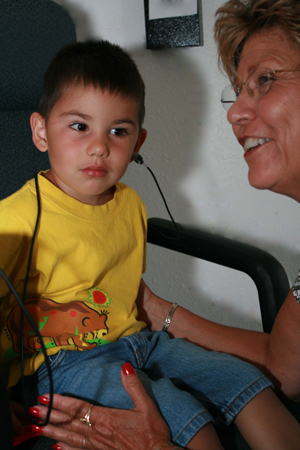 a boy getting a hearing screening
