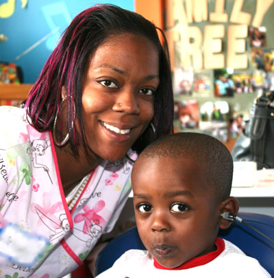 a woman conducting a hearing screening with a young boy