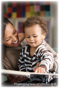 photo of a woman reading with an infant who has a hearing aid
