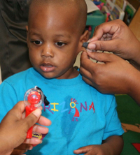 a child in the midst of a hearing screening