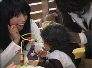 a child getting her hearing tested, links to the training videos page