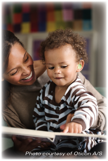 photo of a woman reading with an infant who has a hearing aid