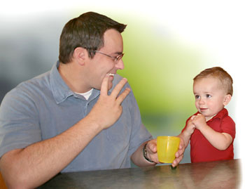 photo of a man signing with a child