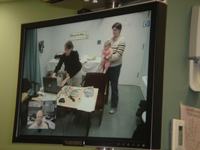 a teleaudiology session in progress, viewed on a computer monitor