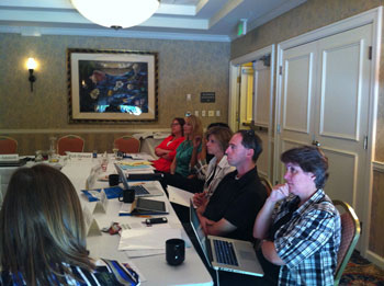 a group of TI professionals considering TI options around a conference table