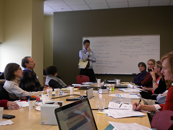 a group of TI professionals considering TI options around a conference table