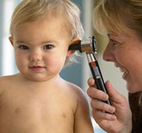 an audiologist checking a baby's hearing