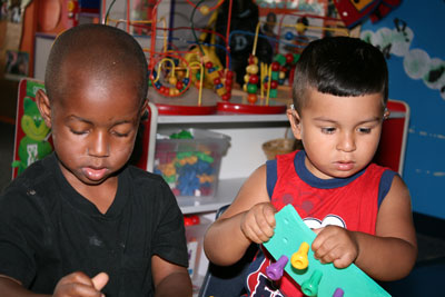 two boys with hearing aids, playing