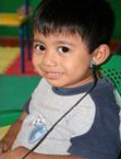 a smiling boy during a hearing screening test