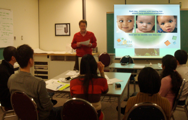 a child participating in a hearing screening test