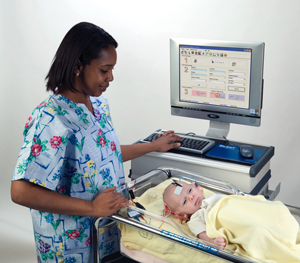 a nurse testing an infant's hearing
