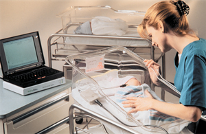 a nurse testing a newborn baby's hearing