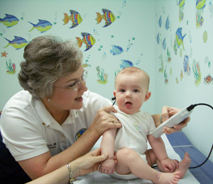 a woman testing a baby's hearing
