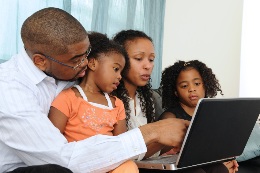 a family gathered around a computer